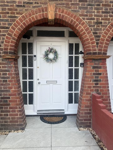 Traditional brick archway and front door of one of our homes
