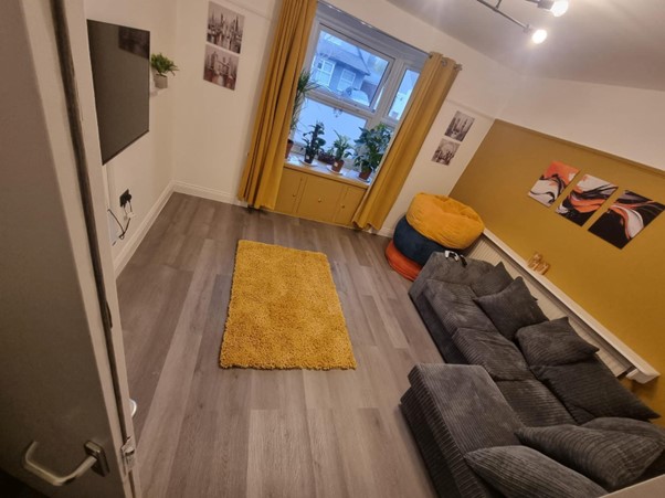 Cosy secondary living room with a games and reading corner